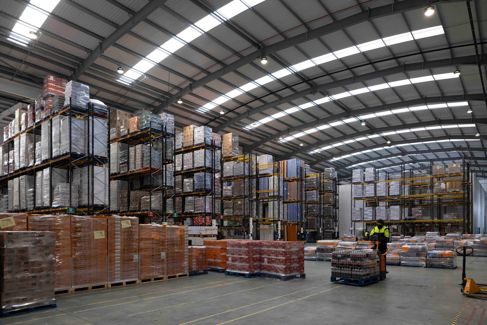 A large warehouse filled with high stacks of pallets